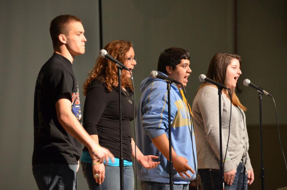 Alliances Highs Roses are Read poetry teams group piece during a performance. From left to right, James Long, Alexis Garrett, Marcos Alvarado, and Crystal Terhune.