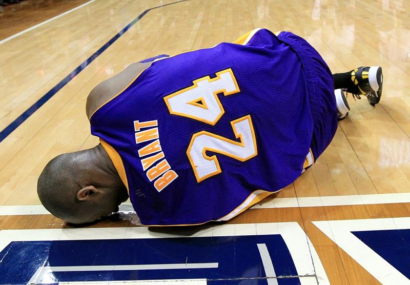 Kobe holds his ankle after injuring it against the Golden State Warriors. 