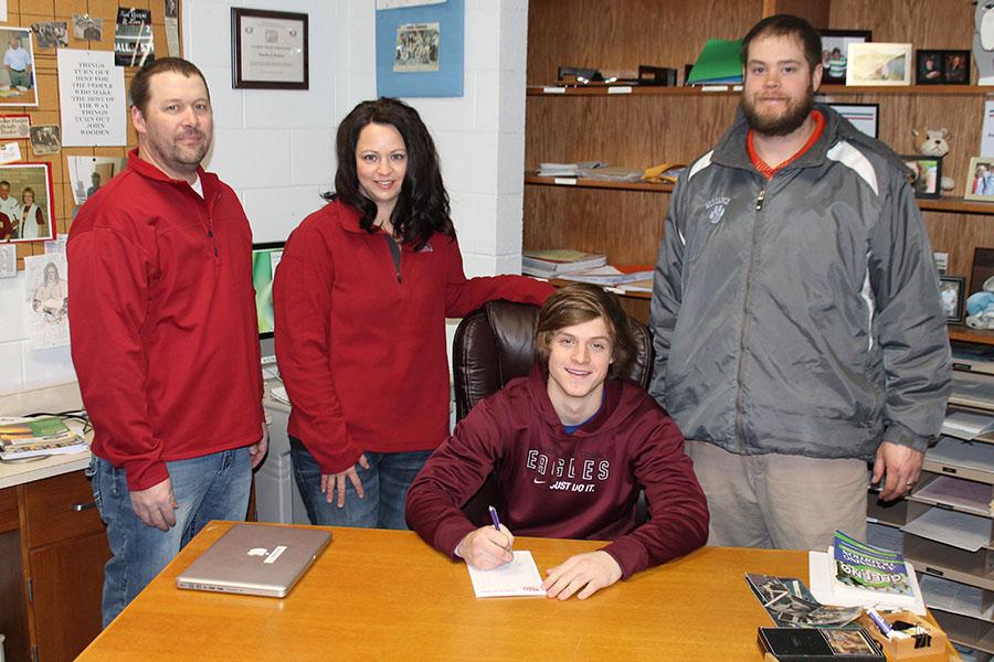 Josh+signing+his+letter-of-intent+to+play+football+for+Chadron+State+with+his+parents+and+assistant+coach+along+side.+From+left+to+right%3A+George+Matulka%2C+Erin+Matulka%2C+Josh+Matulka%2C+and+Bulldog+assistant+coach+Cassidy+Bubba+Kramer.+