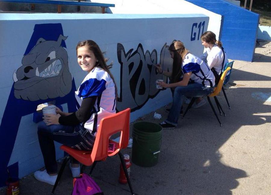 Shae Toof, Marque Crowe and Madison Stark work on the Dawg Pound art.